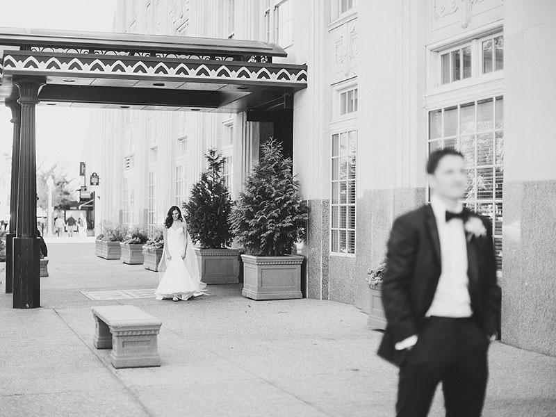 groom waiting on bride out front of hote